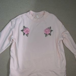 light pink crew neck with floral accents